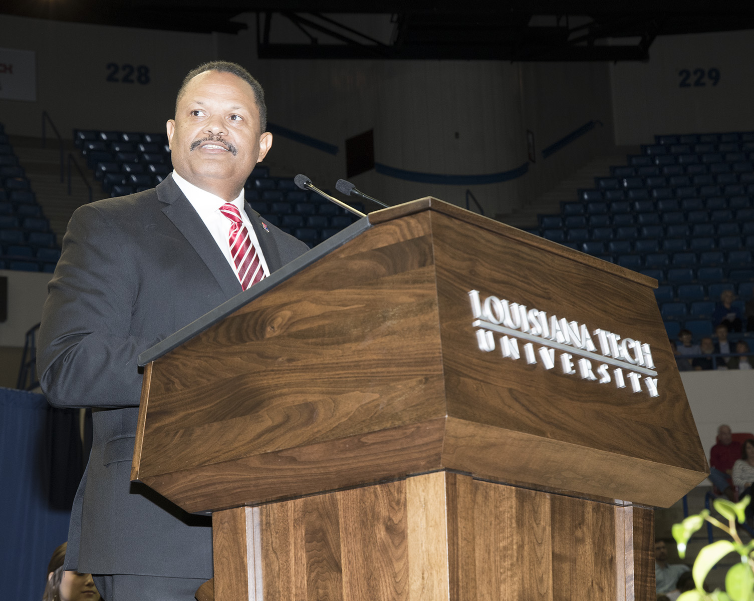 John Belton John Belton speaks at podium during commencement